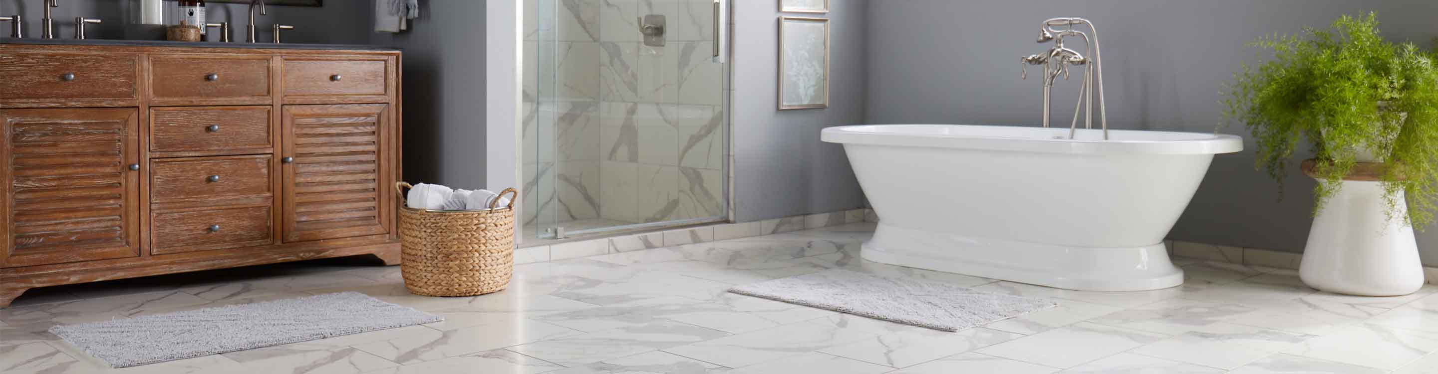 marble tile flooring and shower walls in a bathroom